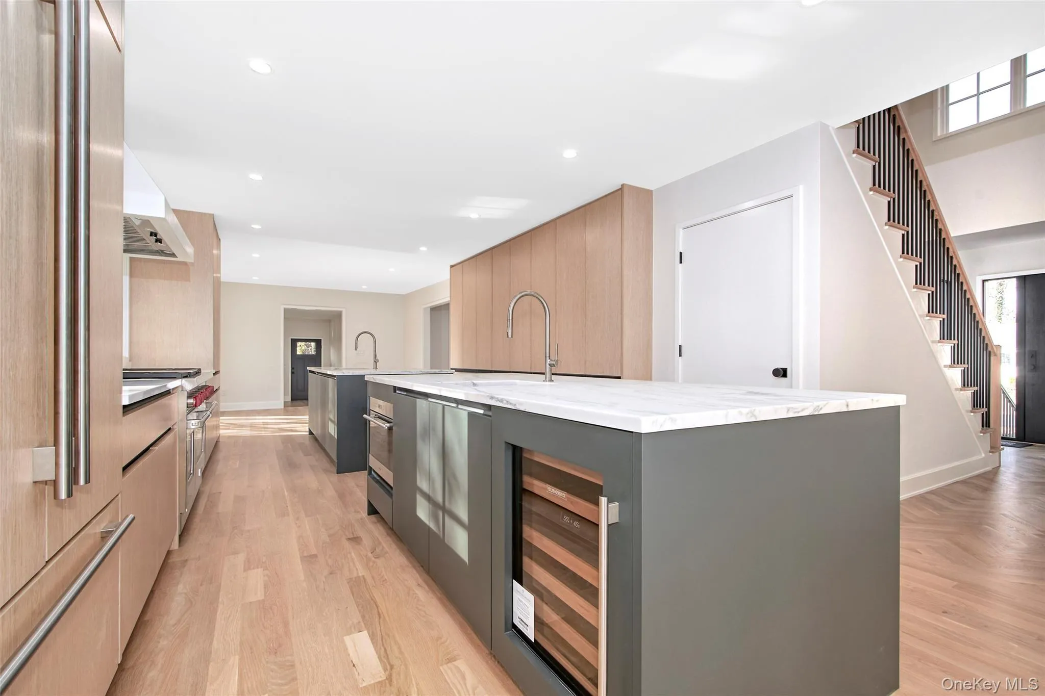 Contemporary kitchen with two islands, sub zero and wolf appliances, cabinets by Ornare and white marble stone. Contemporary kitchen with two islands, sub zero and wolf appliances, cabinets by Ornare and white marble stone.