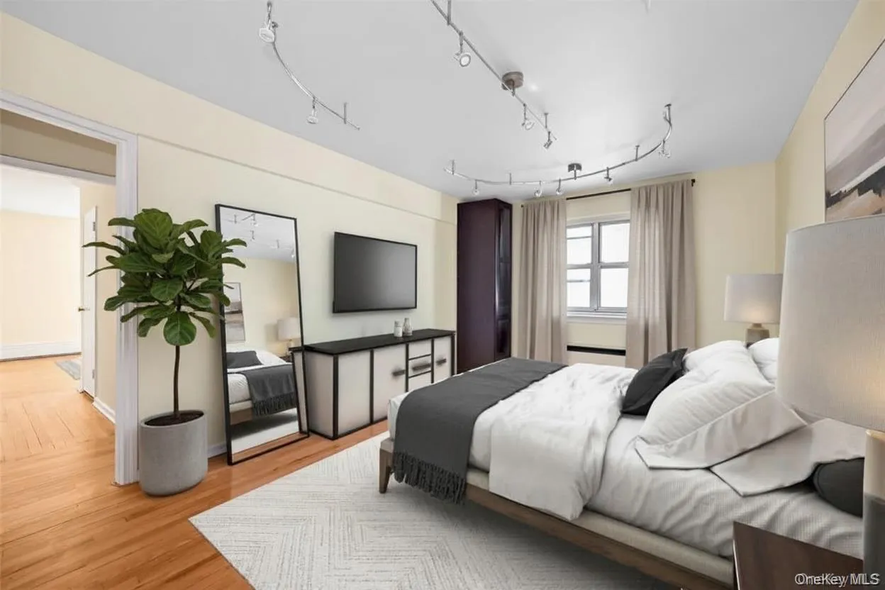 Bedroom featuring light wood-type flooring. Digitally staged. Bedroom featuring light wood-type flooring. Digitally staged.