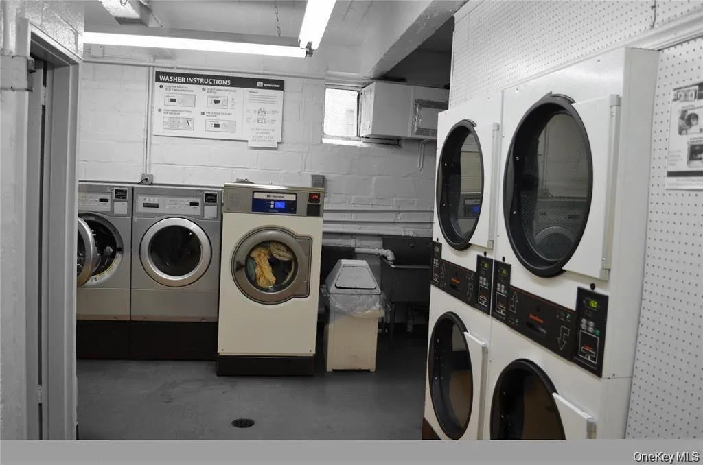 Communal laundry room with stacked washer / drying machine Communal laundry room with stacked washer / drying machine