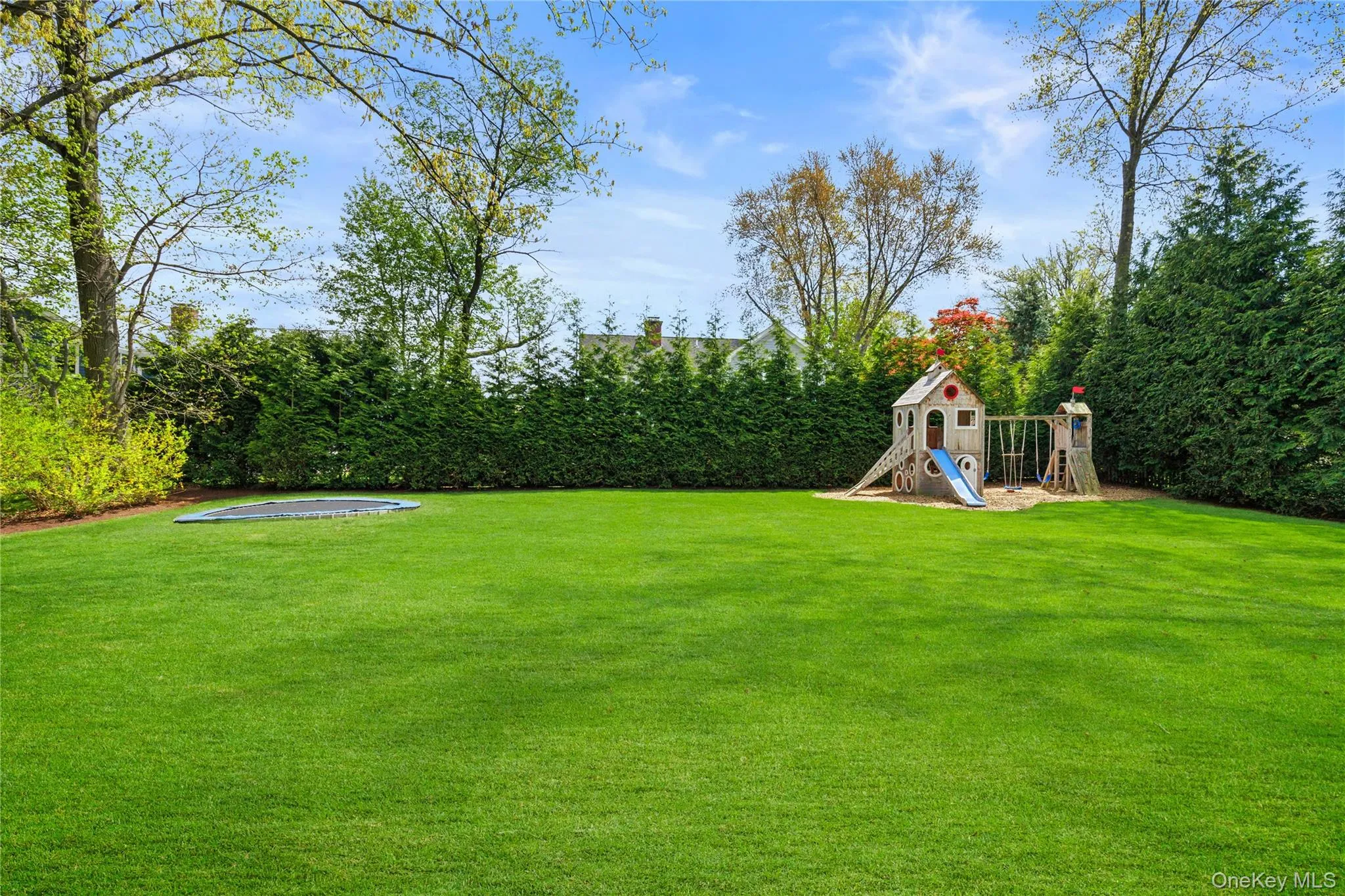 Mature plantings create a private yard with playset and ... Mature plantings create a private yard with playset and ...