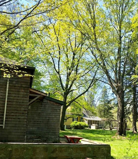 View of property exterior with main house across lawn View of property exterior with main house across lawn