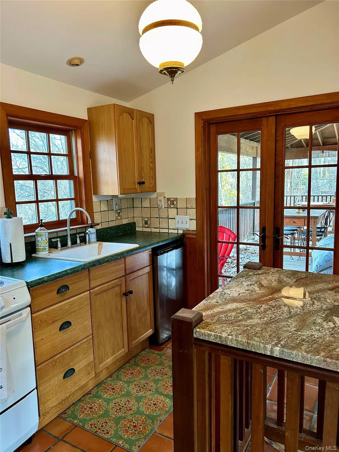 Kitchen featuring french doors, sink, electric range, granite surface. Kitchen featuring french doors, sink, electric range, granite surface.