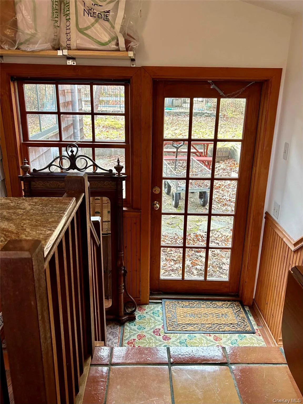 Doorway to outside featuring wood walls Doorway to outside featuring wood walls