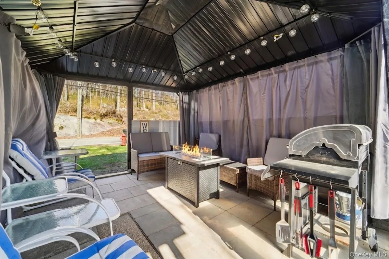 Covered patio with seating and fire table. Covered patio with seating and fire table.