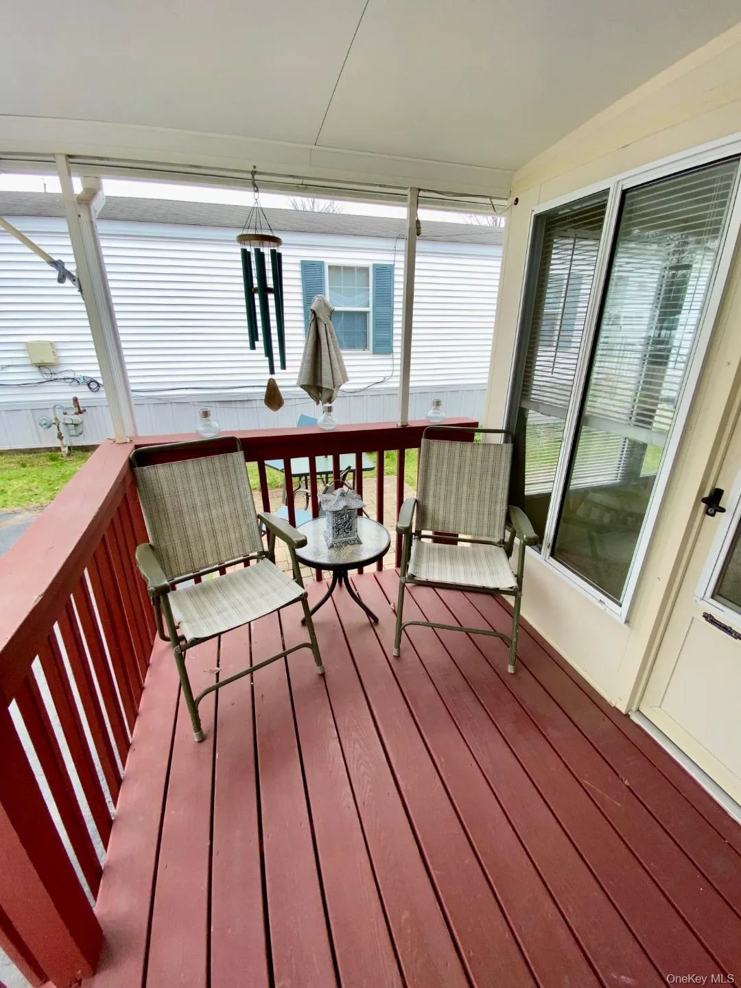 The front deck area has doors to the front entrance and sunroom. The front deck area has doors to the front entrance and sunroom.