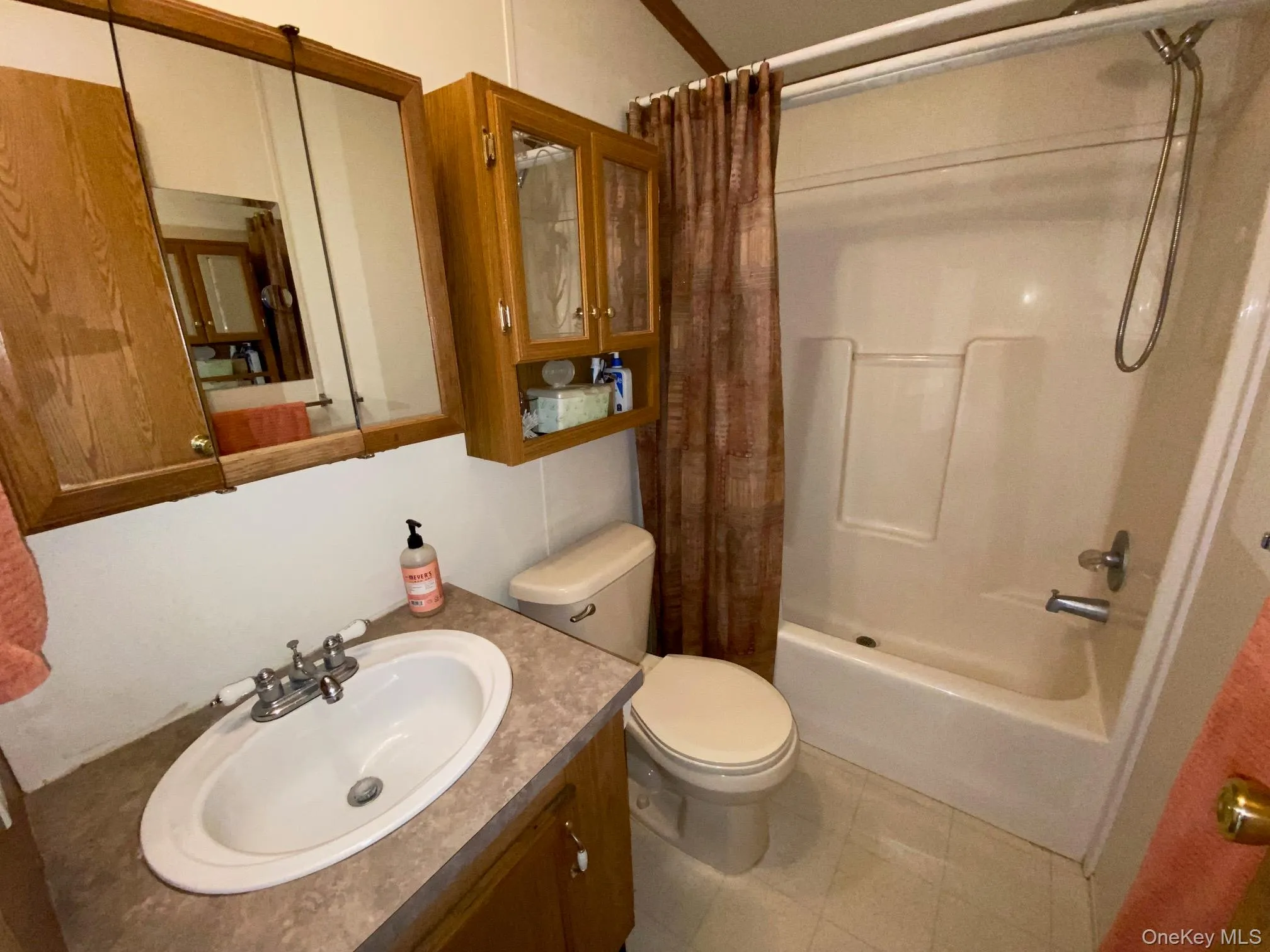 Full bathroom featuring vanity and shower / bath combo Full bathroom featuring vanity and shower / bath combo
