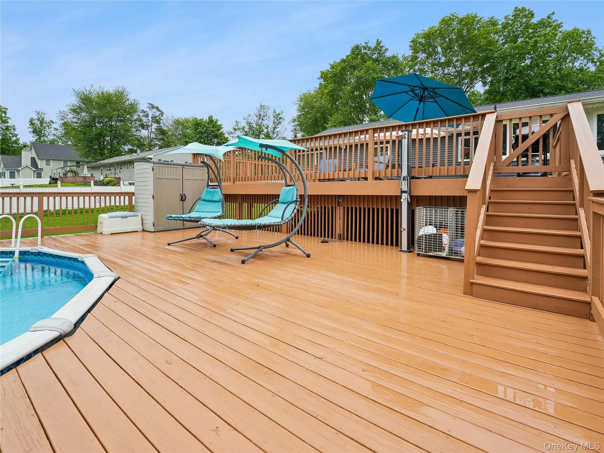 Multi-level wood deck with a built-in above-ground pool Multi-level wood deck with a built-in above-ground pool