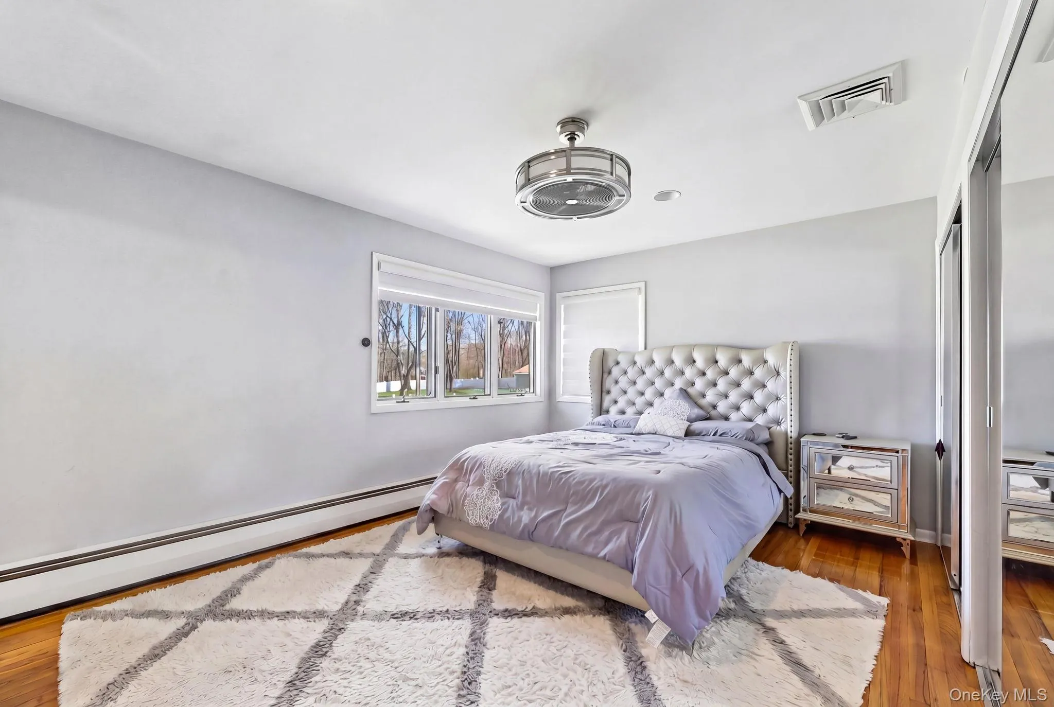Master Bedroom featuring hardwood flooring with automatic shades. Master Bedroom featuring hardwood flooring with automatic shades.