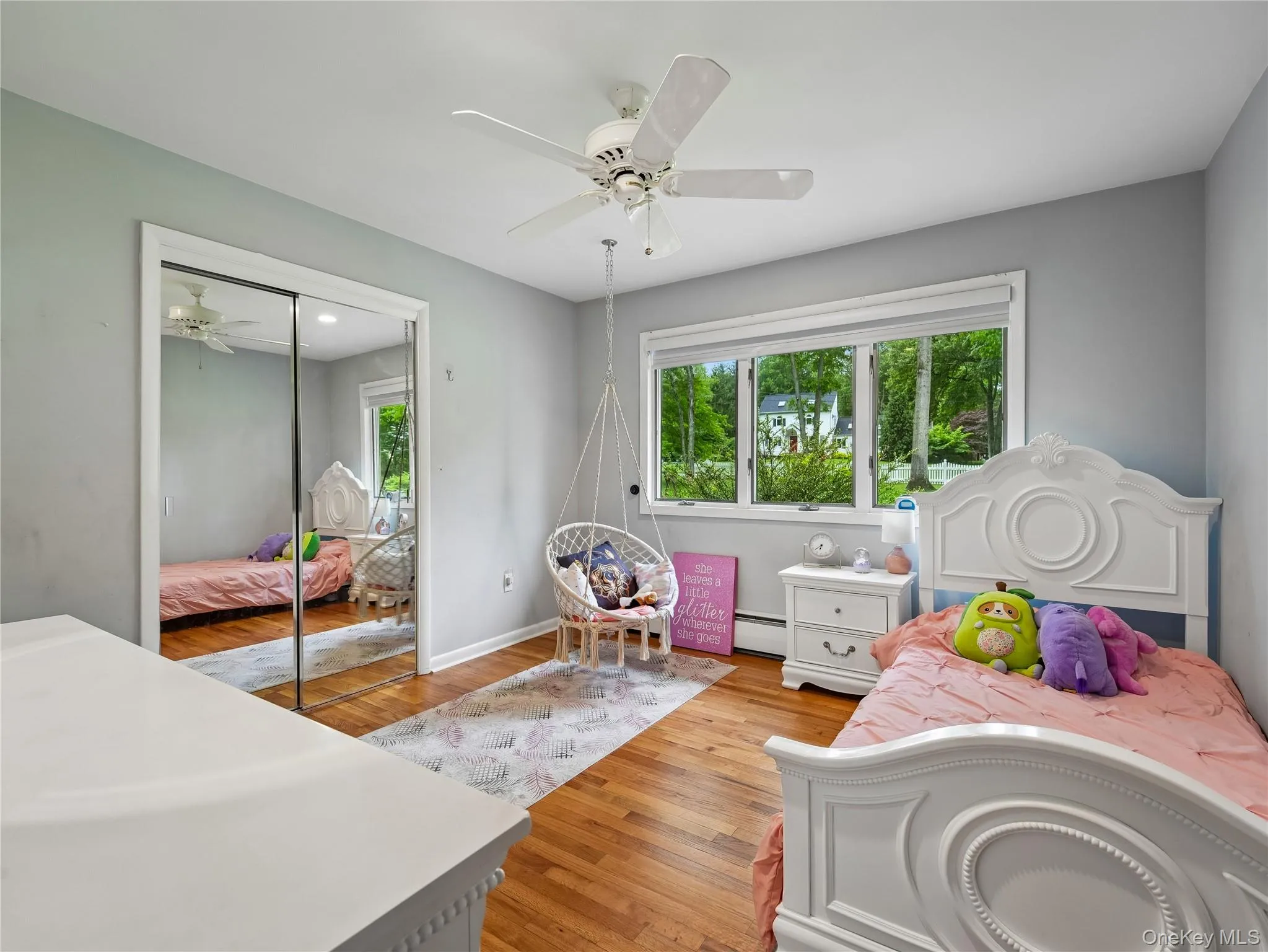 Second bright room featuring hardwood flooring and a ceiling fan. Second bright room featuring hardwood flooring and a ceiling fan.