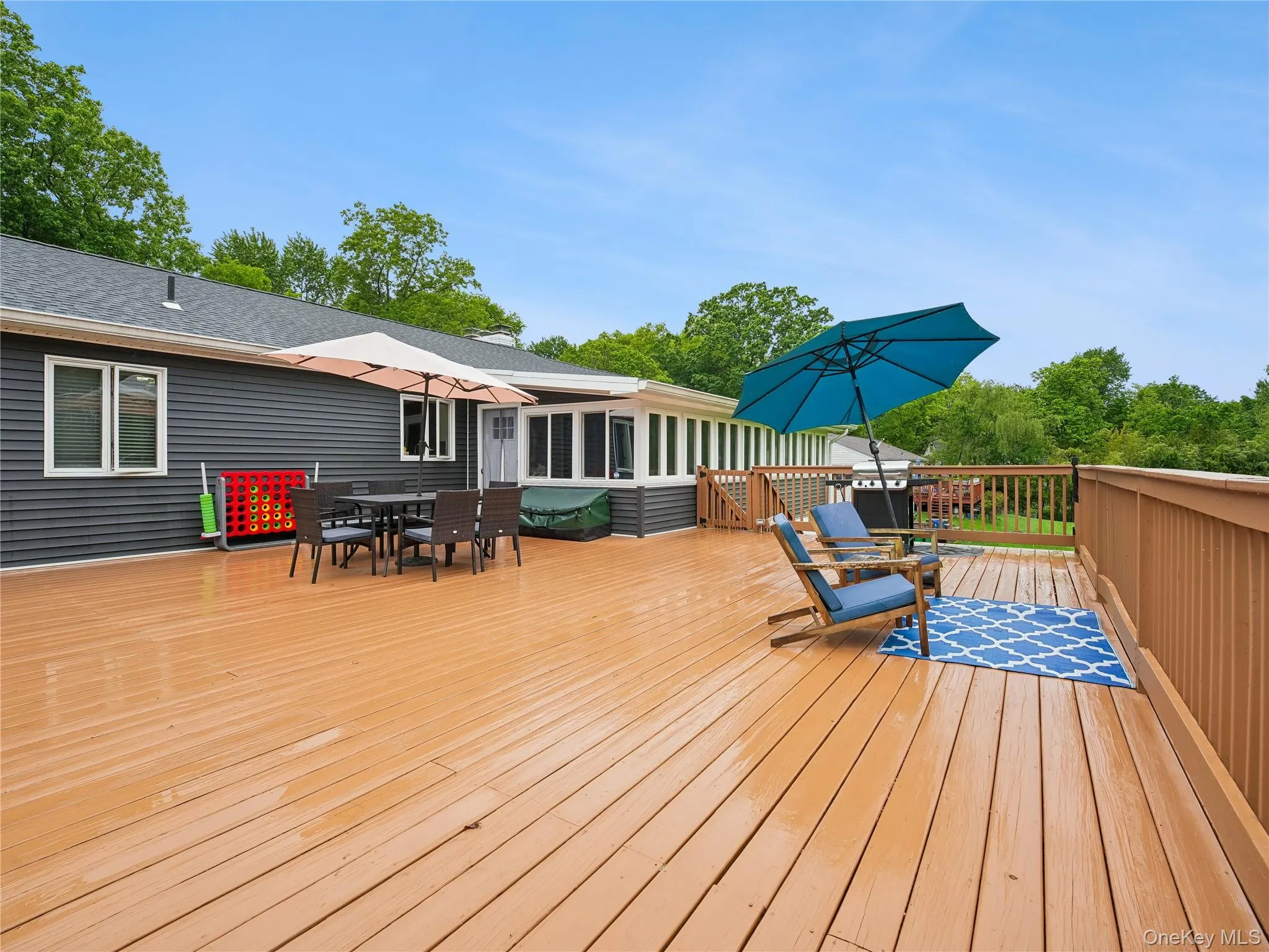 Expansive wood-finish deck newly painted. Expansive wood-finish deck newly painted.
