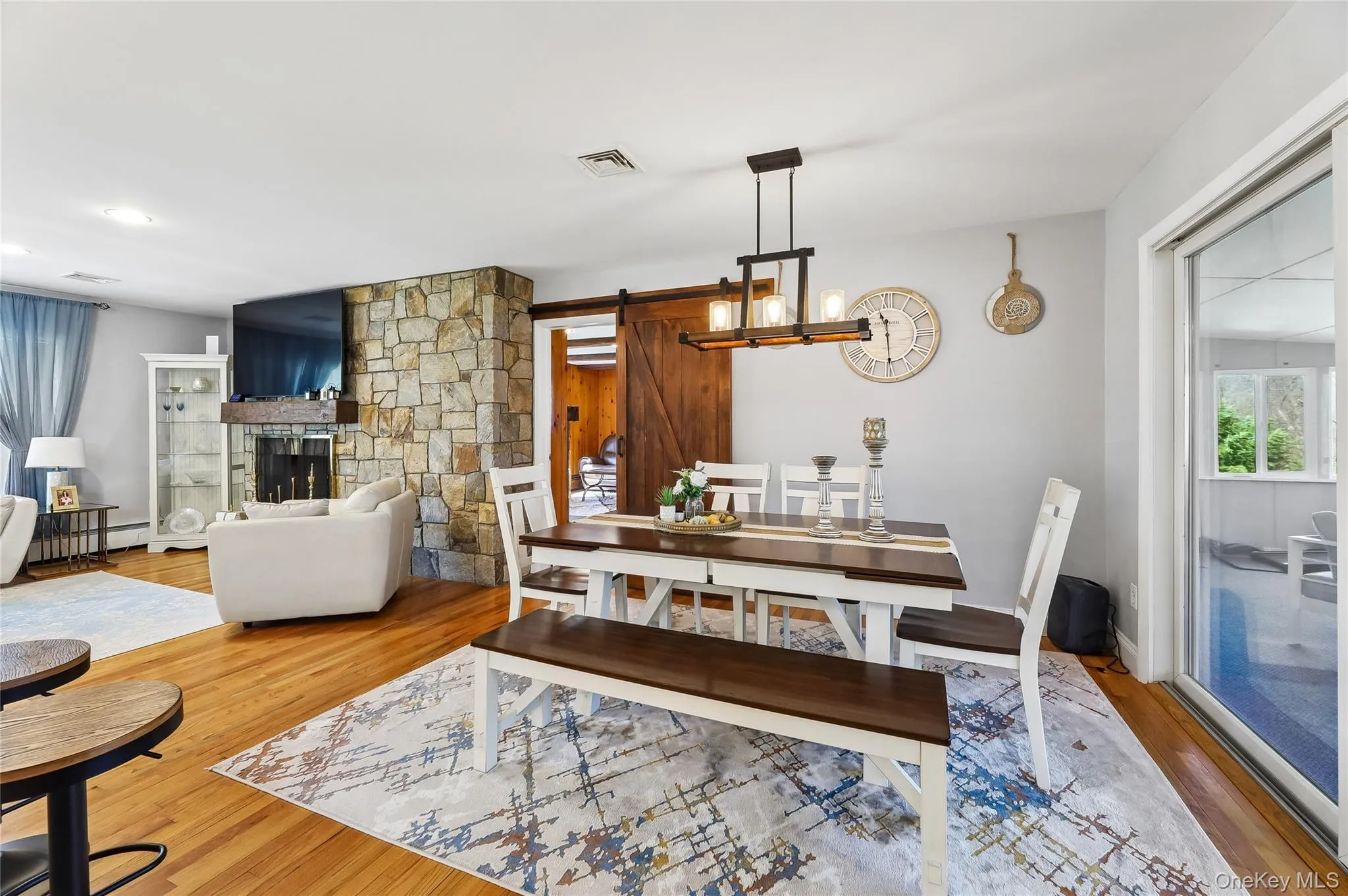 Open-concept living and dining area featuring hard wood-finish flooring. Open-concept living and dining area featuring hard wood-finish flooring.