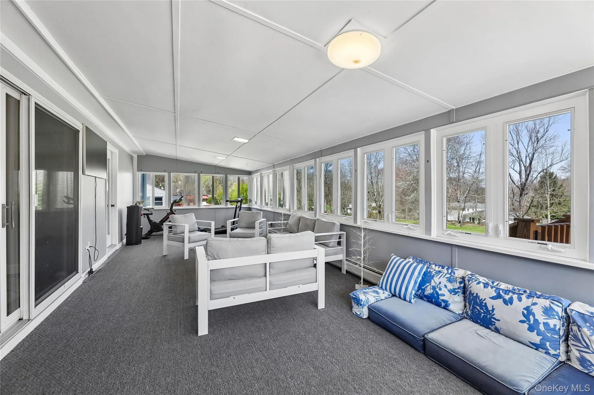 Spacious sunroom featuring extensive window-line. Spacious sunroom featuring extensive window-line.