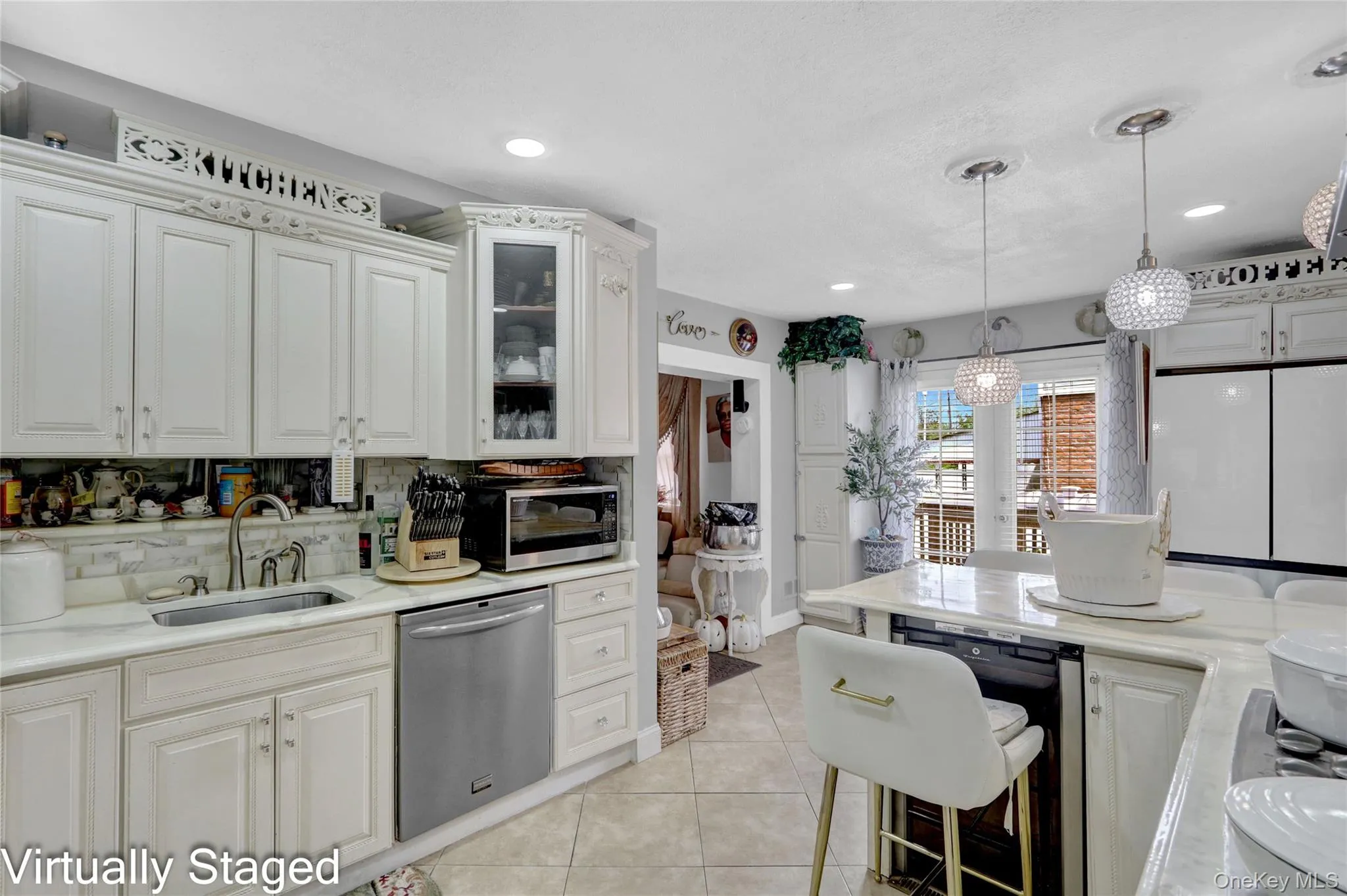Kitchen featuring glass fronted cabinets, stainless steel appliances, white cabinets, light tile patterned flooring, and light stone counters Kitchen featuring glass fronted cabinets, stainless steel appliances, white cabinets, light tile patterned flooring, and light stone counters