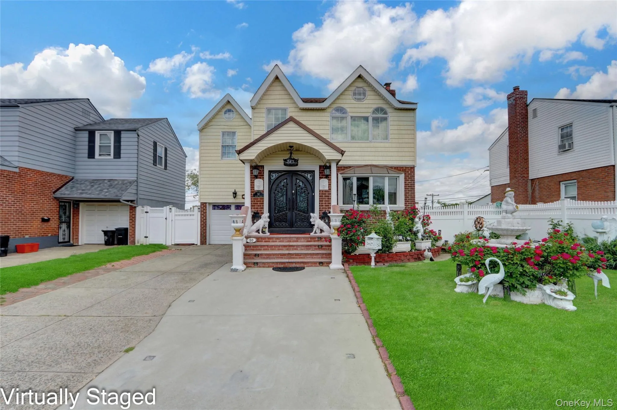 View of front of property with concrete driveway, a gate, and brick siding View of front of property with concrete driveway, a gate, and brick siding