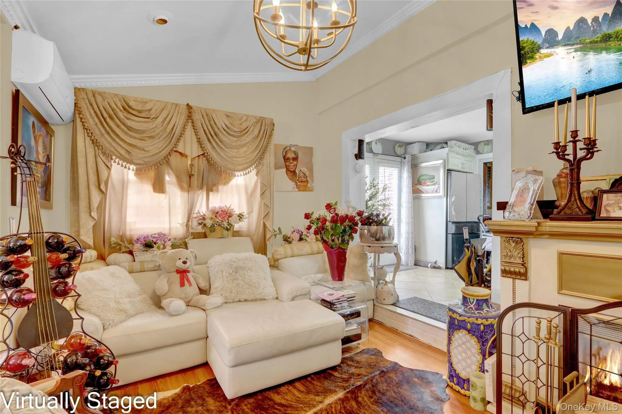Living area with suspended lighting, wood finished floors, and crown molding Living area with suspended lighting, wood finished floors, and crown molding