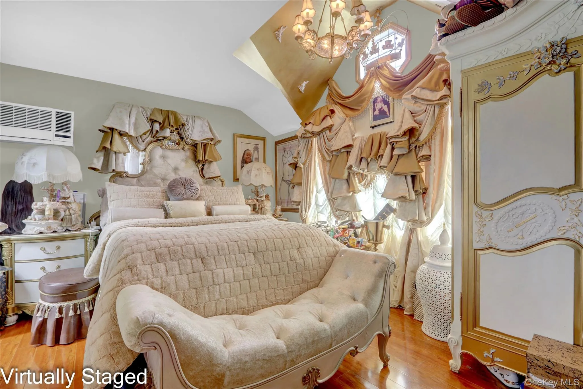 Bedroom featuring hanging lights, lofted ceiling, light wood finished floors, and multiple windows Bedroom featuring hanging lights, lofted ceiling, light wood finished floors, and multiple windows
