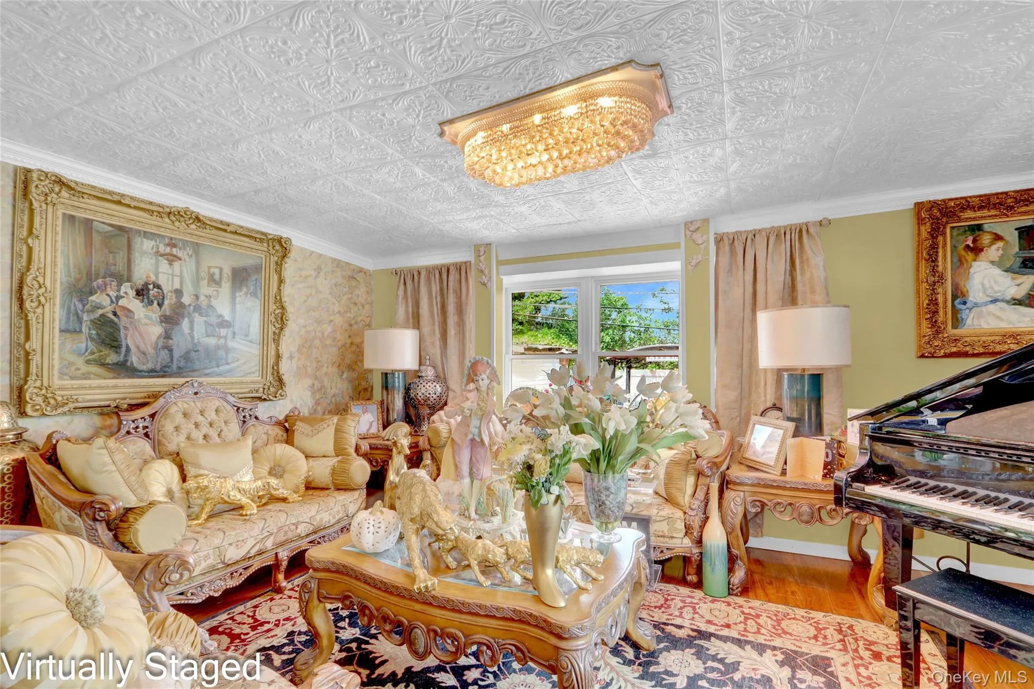Living room featuring wood finished floors, an ornate ceiling, and crown molding Living room featuring wood finished floors, an ornate ceiling, and crown molding