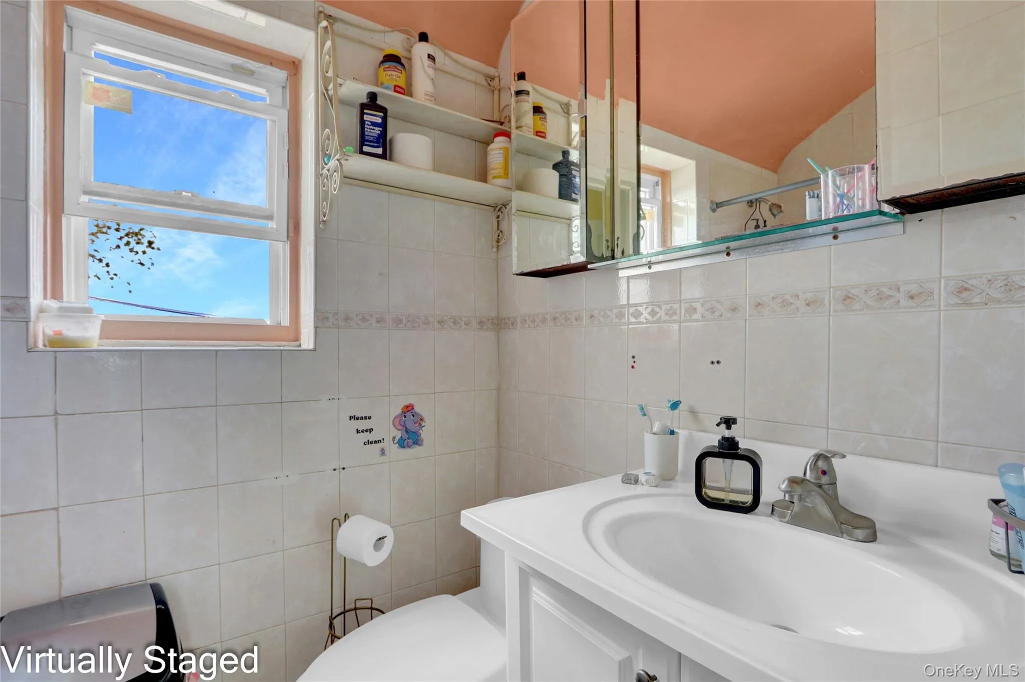 Full bathroom with vanity, tile walls, plenty of natural light, backsplash, and a shower with shower curtain Full bathroom with vanity, tile walls, plenty of natural light, backsplash, and a shower with shower curtain