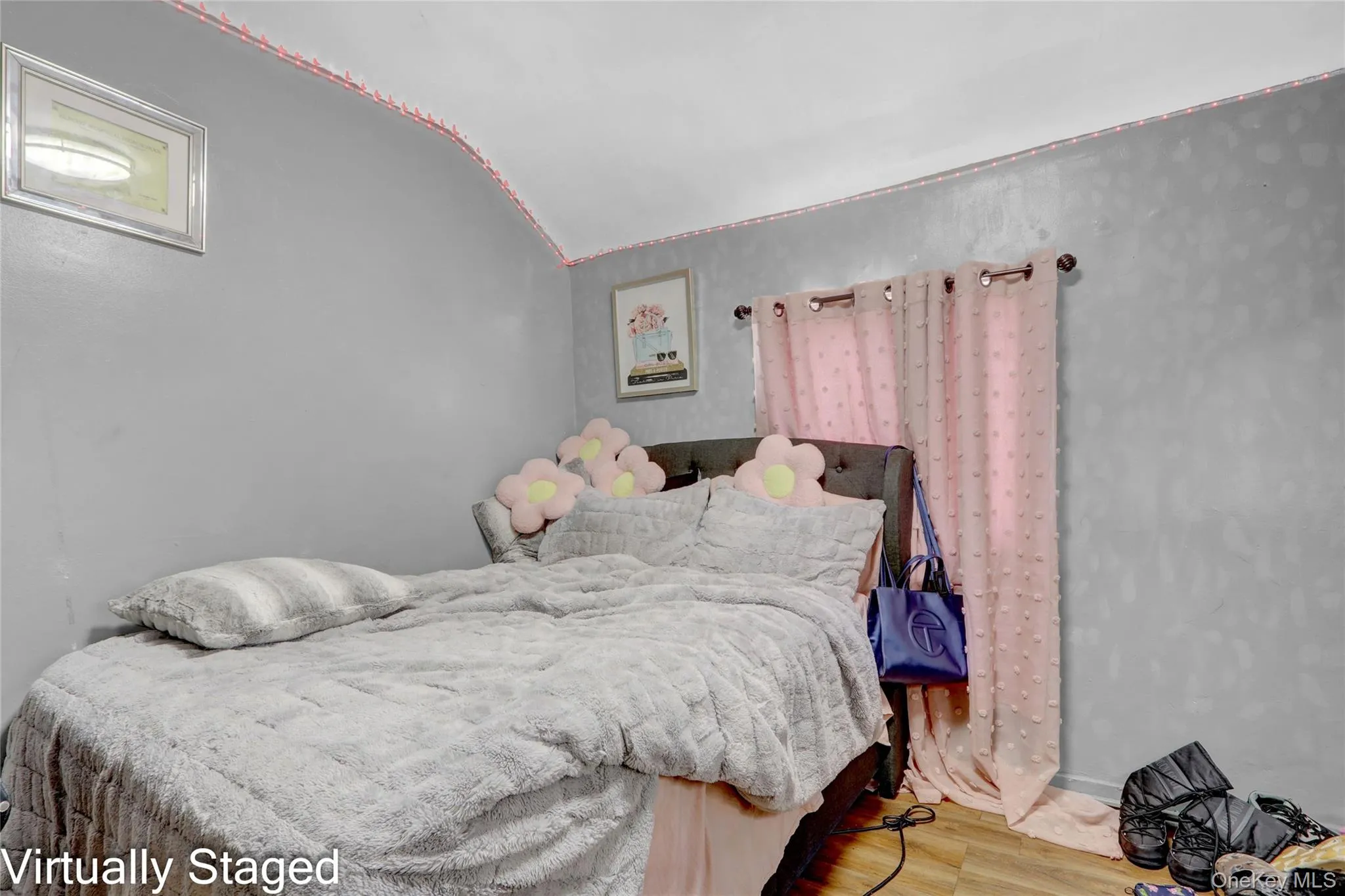 Bedroom with light wood-type flooring and lofted ceiling Bedroom with light wood-type flooring and lofted ceiling