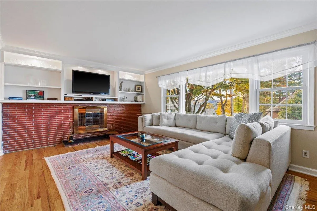 Living room with wood burning fireplace and bay window Living room with wood burning fireplace and bay window