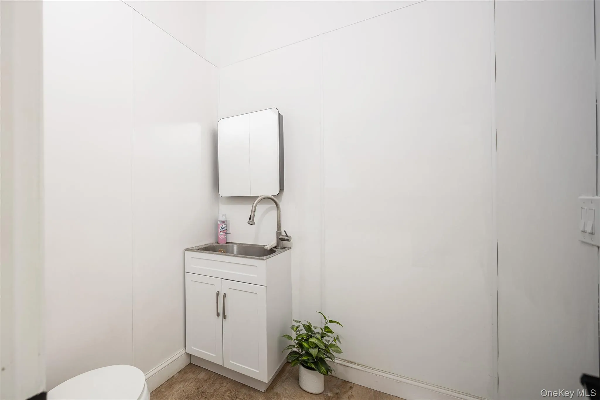 Half bathroom with vanity and toilet Half bathroom with vanity and toilet