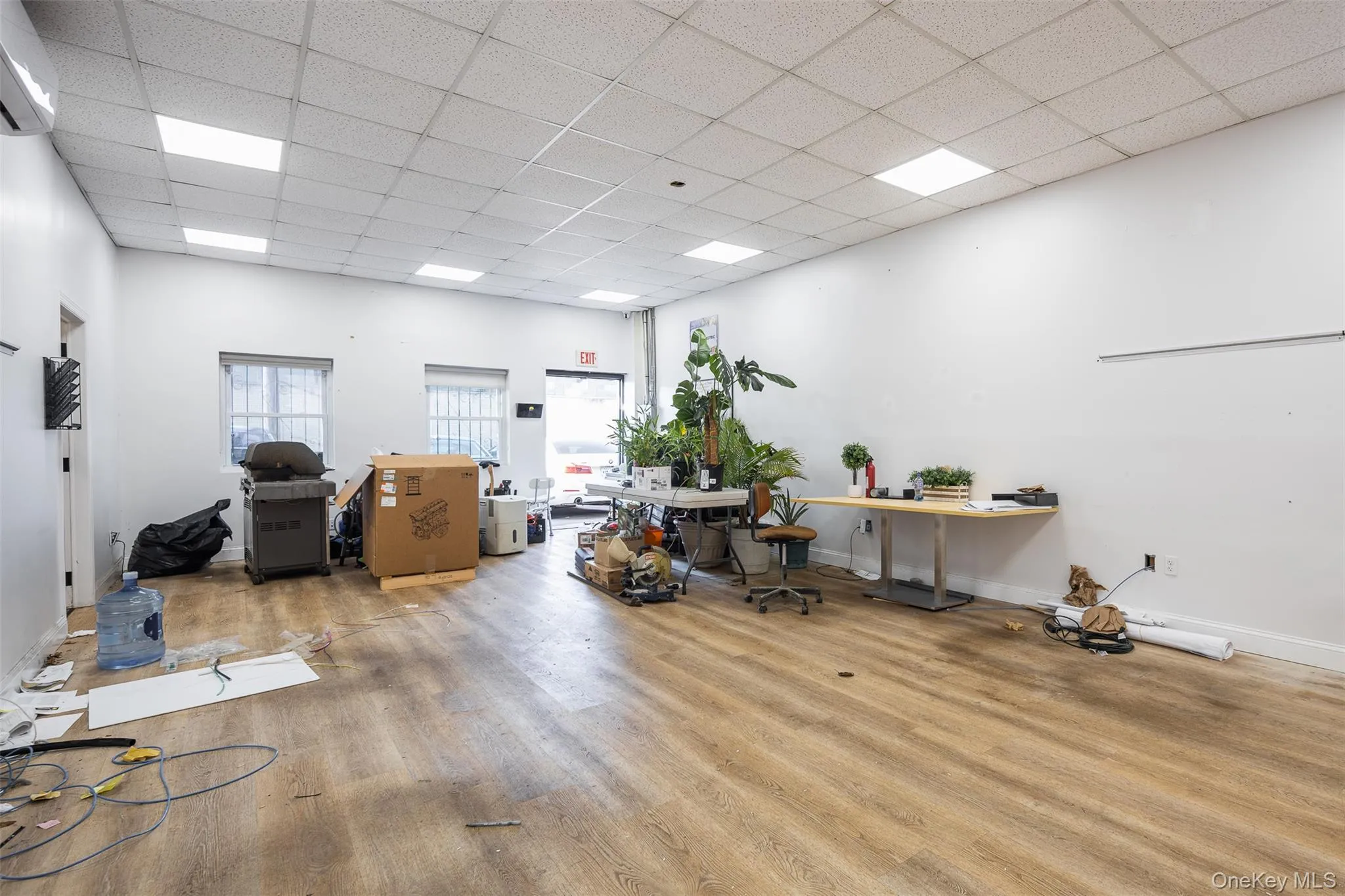 Miscellaneous room featuring a wall mounted mini split and a paneled ceiling Miscellaneous room featuring a wall mounted mini split and a paneled ceiling