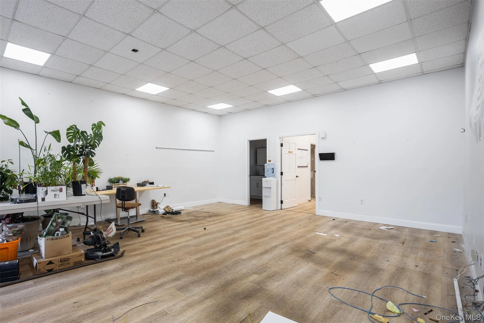 office with a paneled ceiling & wood flooring office with a paneled ceiling & wood flooring