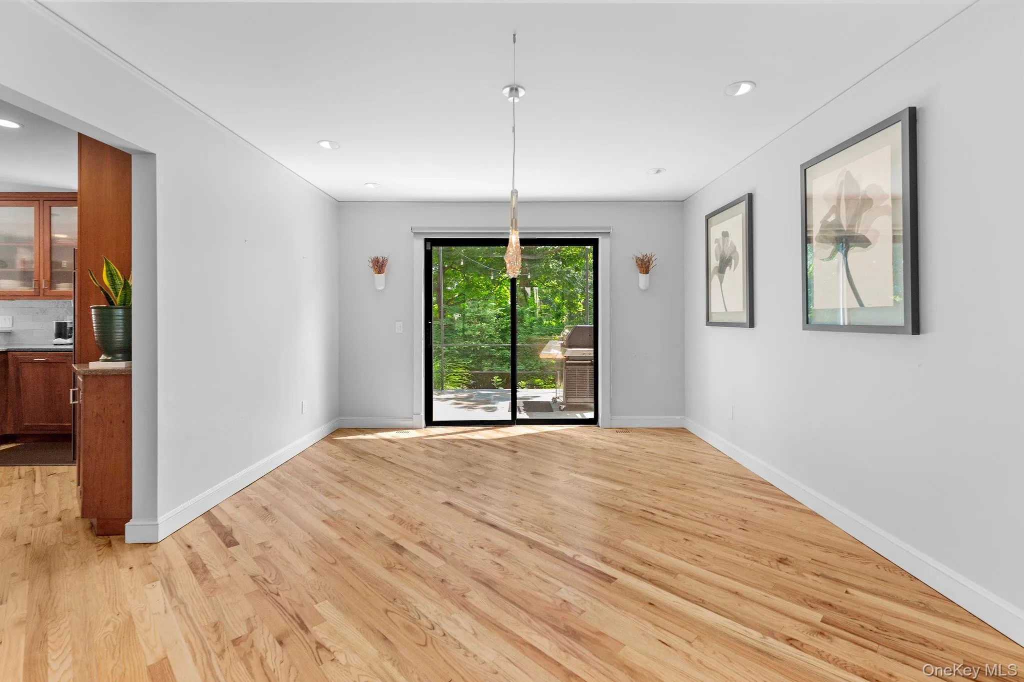 Unfurnished dining area featuring light wood finished floors, baseboards, and recessed lighting Unfurnished dining area featuring light wood finished floors, baseboards, and recessed lighting