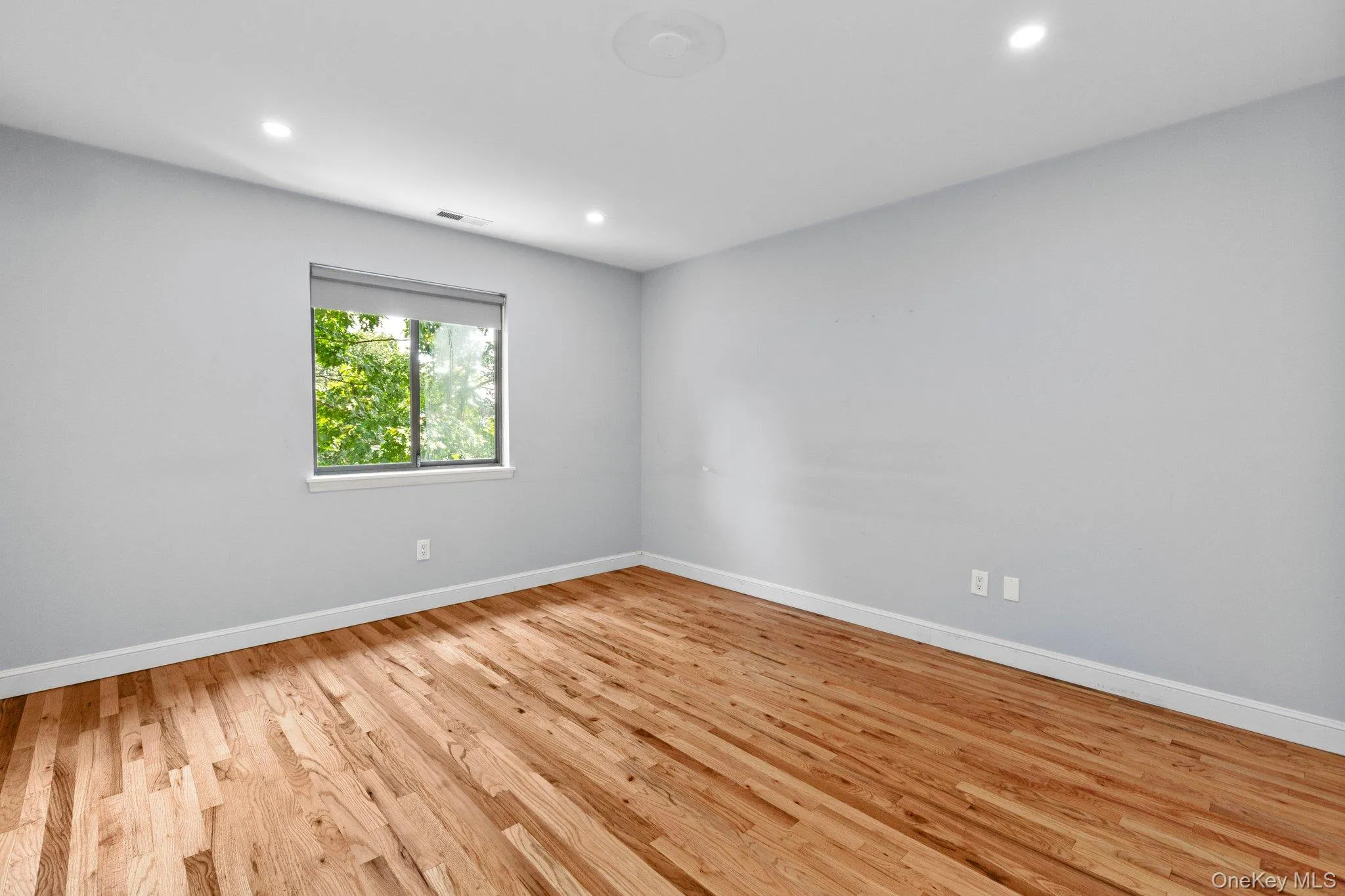 Unfurnished room with baseboards, visible vents, recessed lighting, and light wood-type flooring Unfurnished room with baseboards, visible vents, recessed lighting, and light wood-type flooring