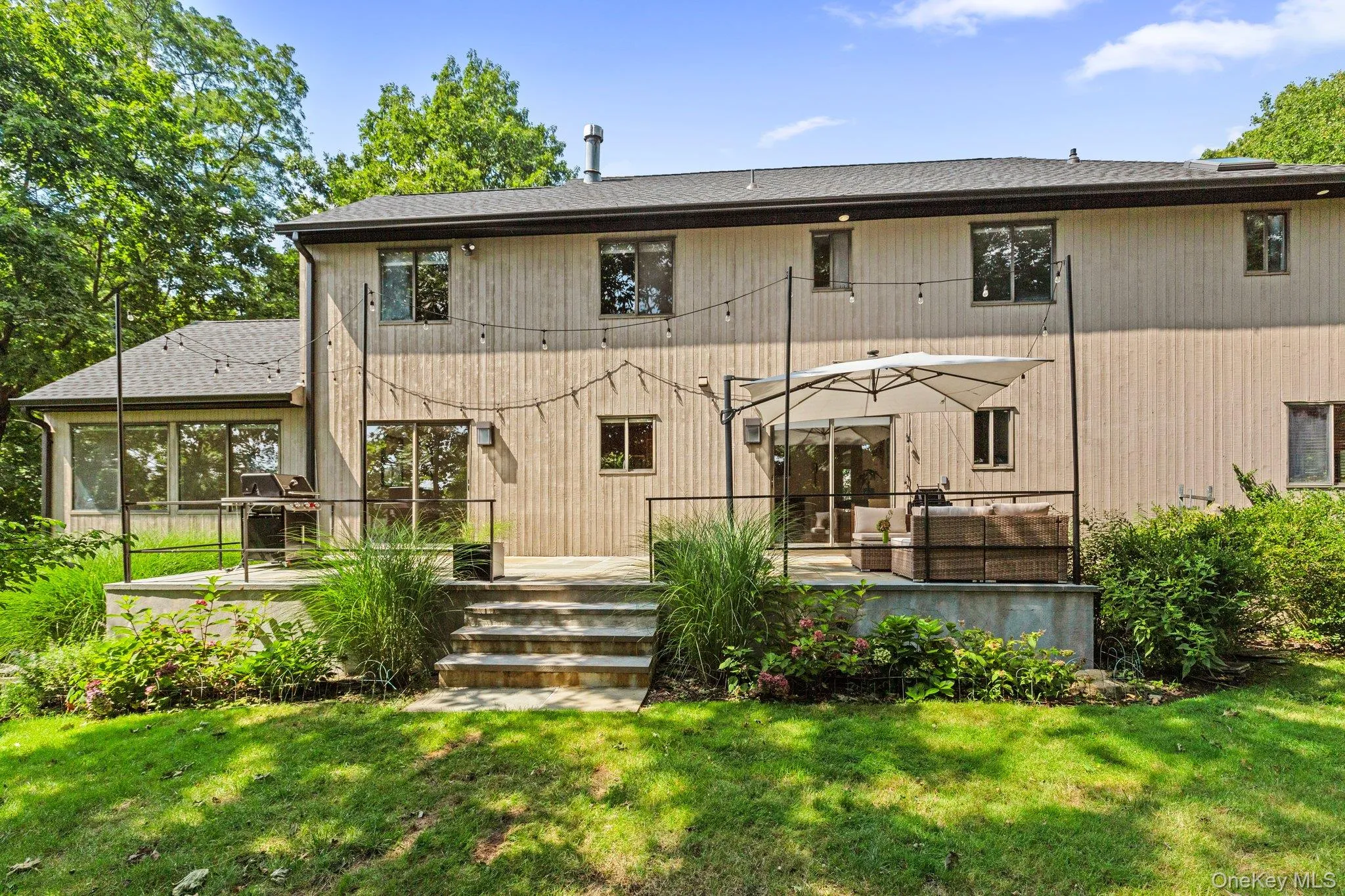 Back of property with a lawn and a deck Back of property with a lawn and a deck