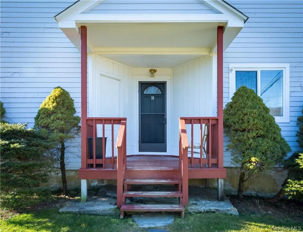 The first-floor apartment has a private entrance from a covered front porch. The first-floor apartment has a private entrance from a covered front porch.