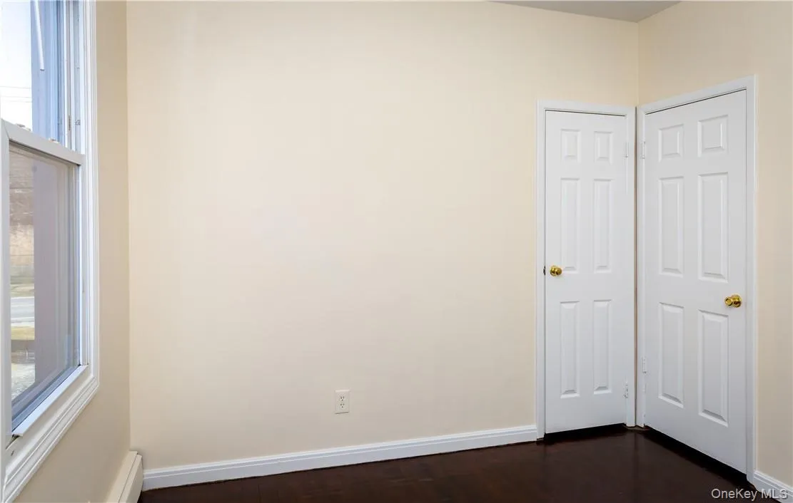 View of back bedroom, closet and door to hallway off of kitchen. View of back bedroom, closet and door to hallway off of kitchen.