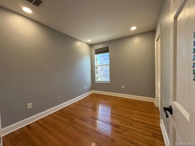 Spare room featuring hardwood / wood-style flooring and recessed lighting Spare room featuring hardwood / wood-style flooring and recessed lighting