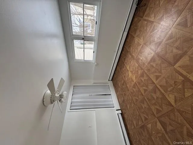 Spare room with a baseboard radiator and a ceiling fan Spare room with a baseboard radiator and a ceiling fan