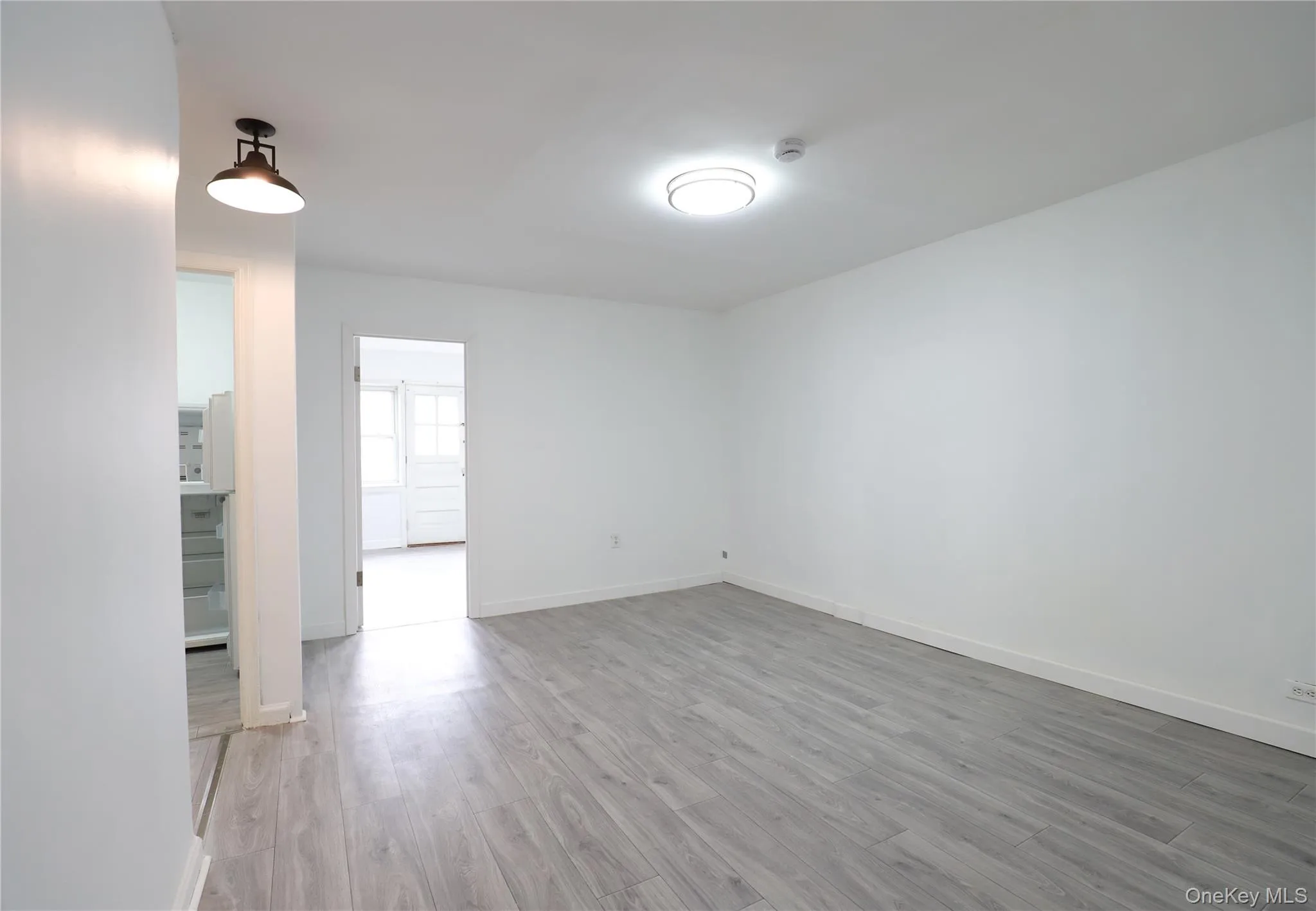 Empty room featuring light wood-style floors and baseboards Empty room featuring light wood-style floors and baseboards