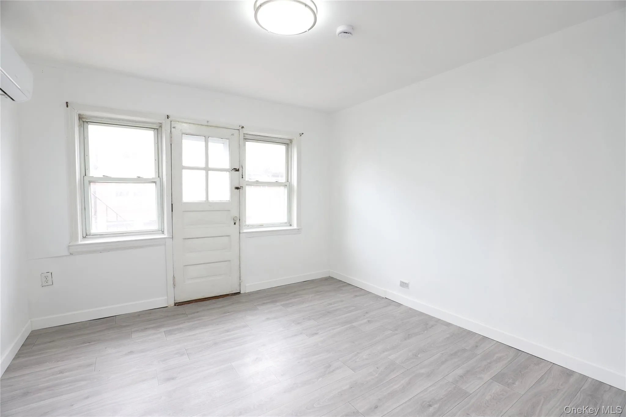 Unfurnished room featuring baseboards and light wood finished floors Unfurnished room featuring baseboards and light wood finished floors