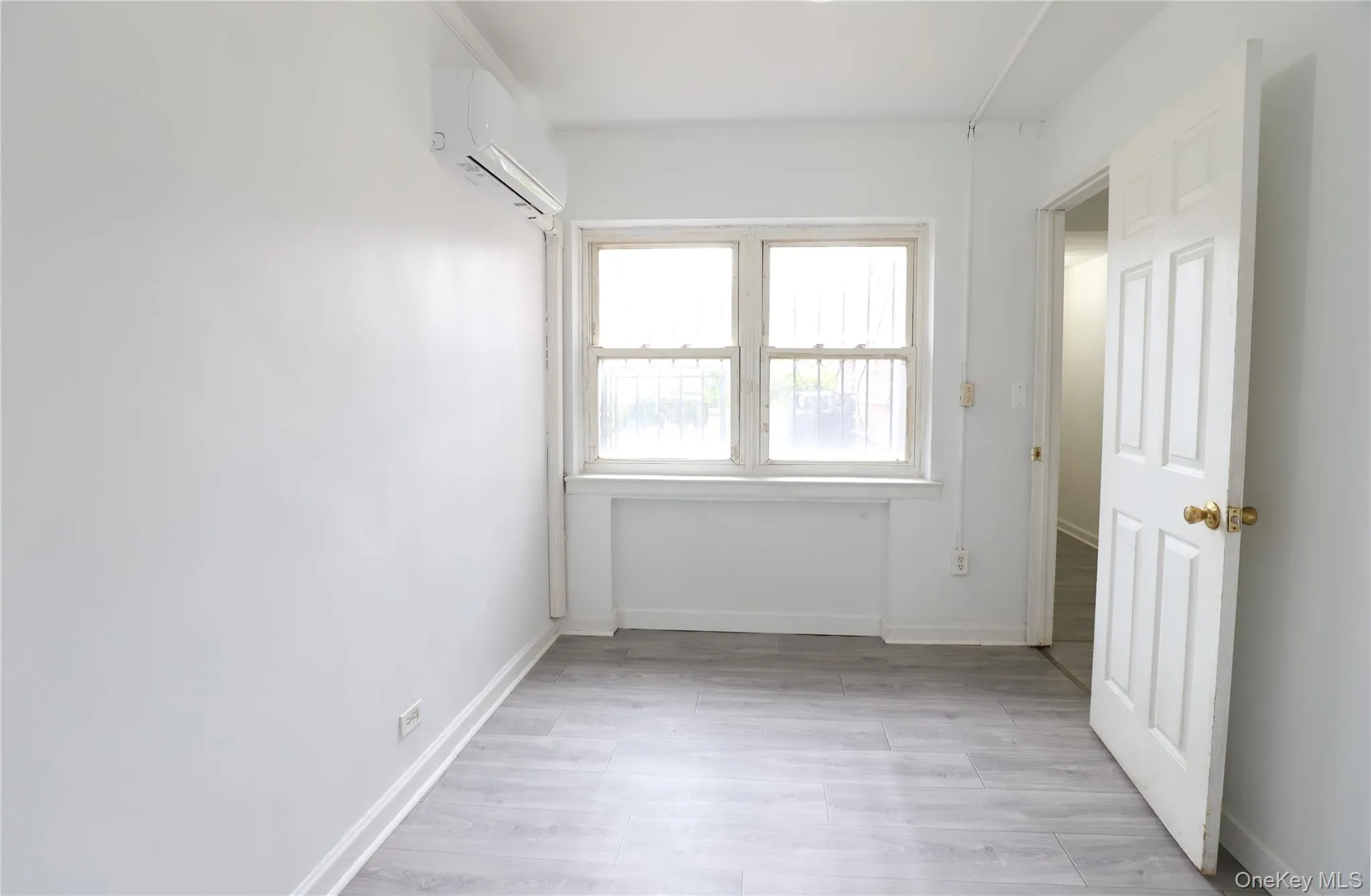 Spare room featuring baseboards and light wood-style flooring Spare room featuring baseboards and light wood-style flooring