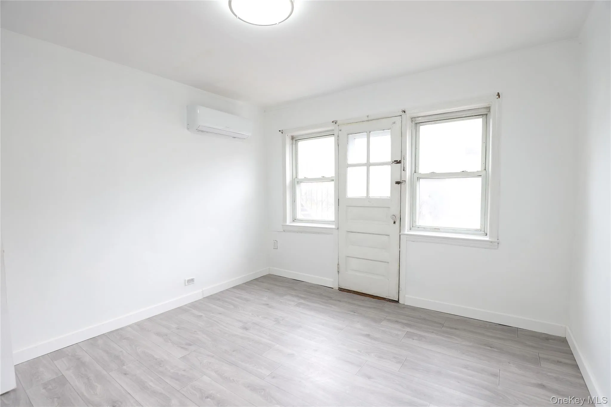 Unfurnished room featuring light wood-type flooring and baseboards Unfurnished room featuring light wood-type flooring and baseboards