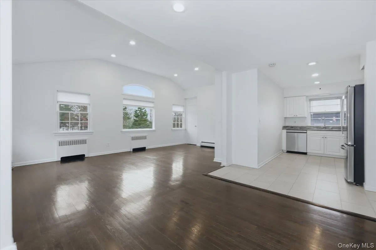 Wood floors, architectural window, vaulted ceiling Wood floors, architectural window, vaulted ceiling
