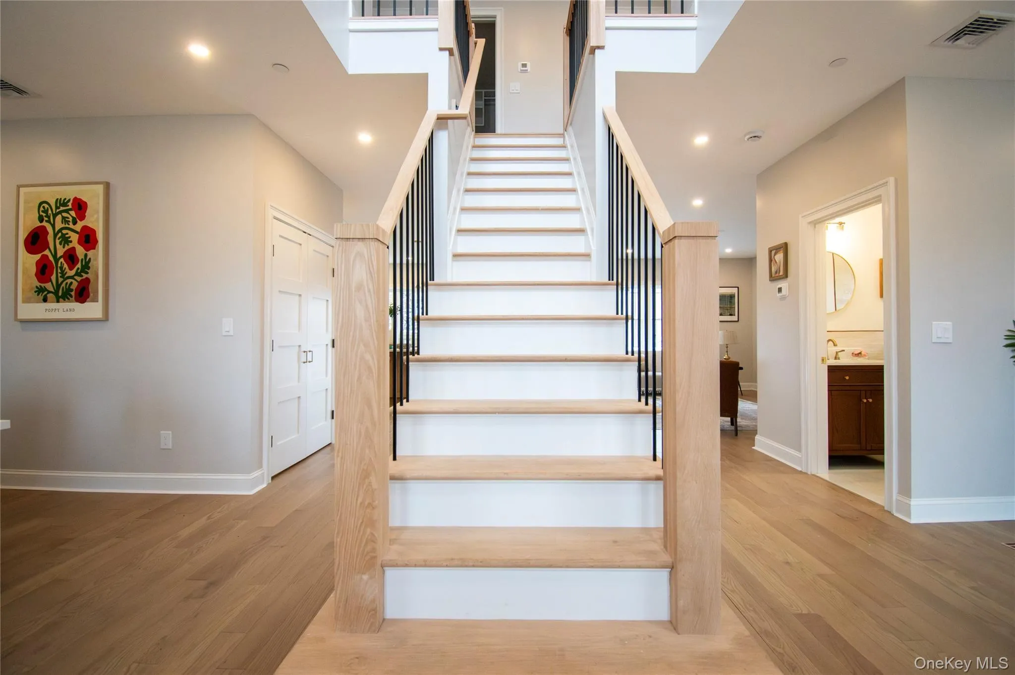 Stairs featuring wood finished floors and recessed lighting Stairs featuring wood finished floors and recessed lighting