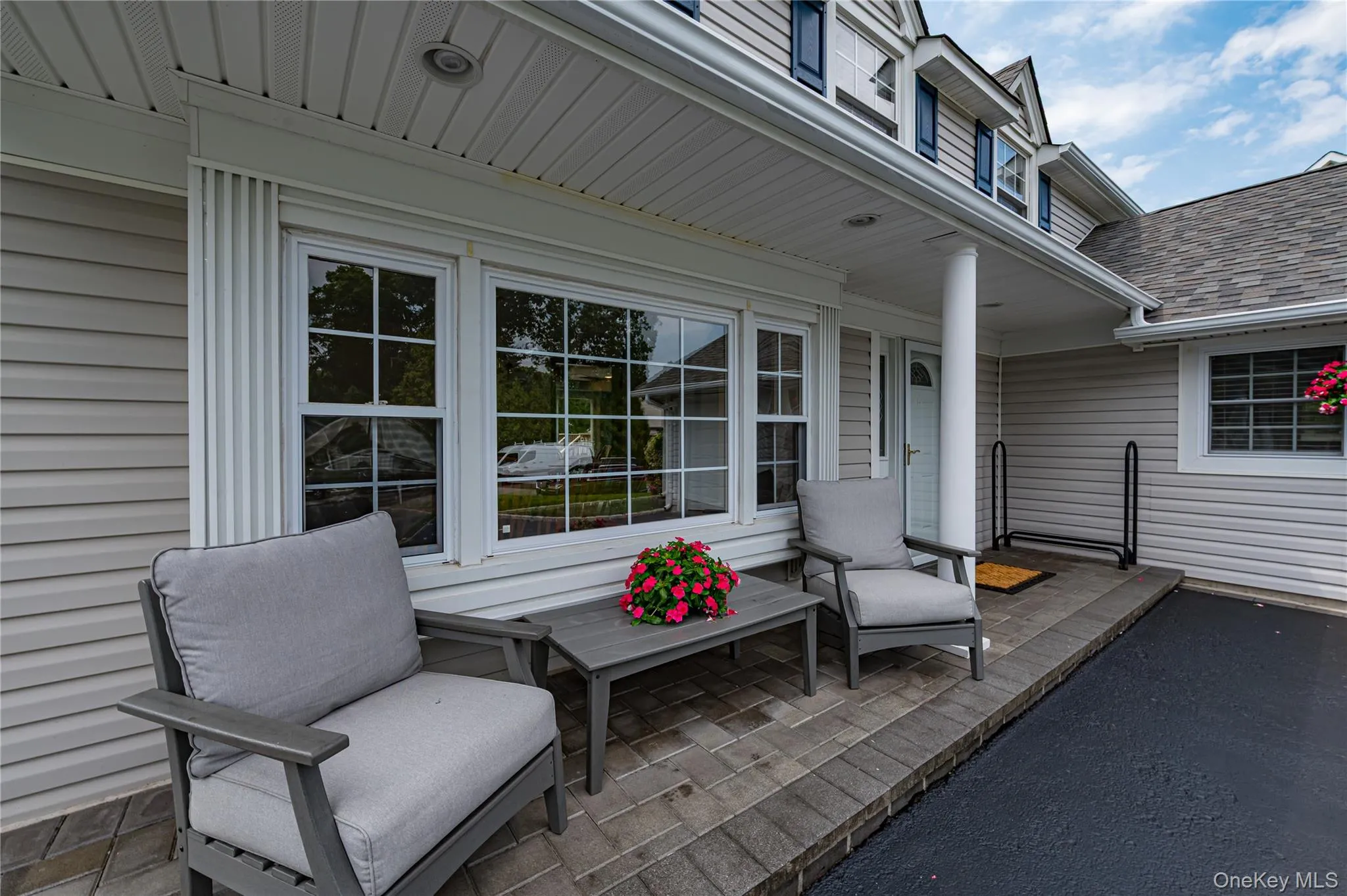 Covered front entrance featuring a support column and white paneled door Covered front entrance featuring a support column and white paneled door