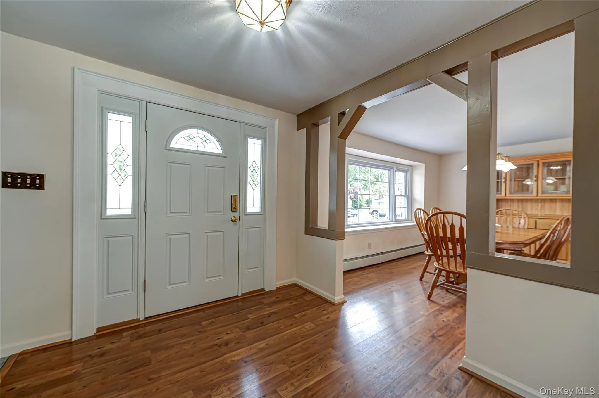 Front entry featuring a white paneled door with a semi-circular transom and side lights Front entry featuring a white paneled door with a semi-circular transom and side lights