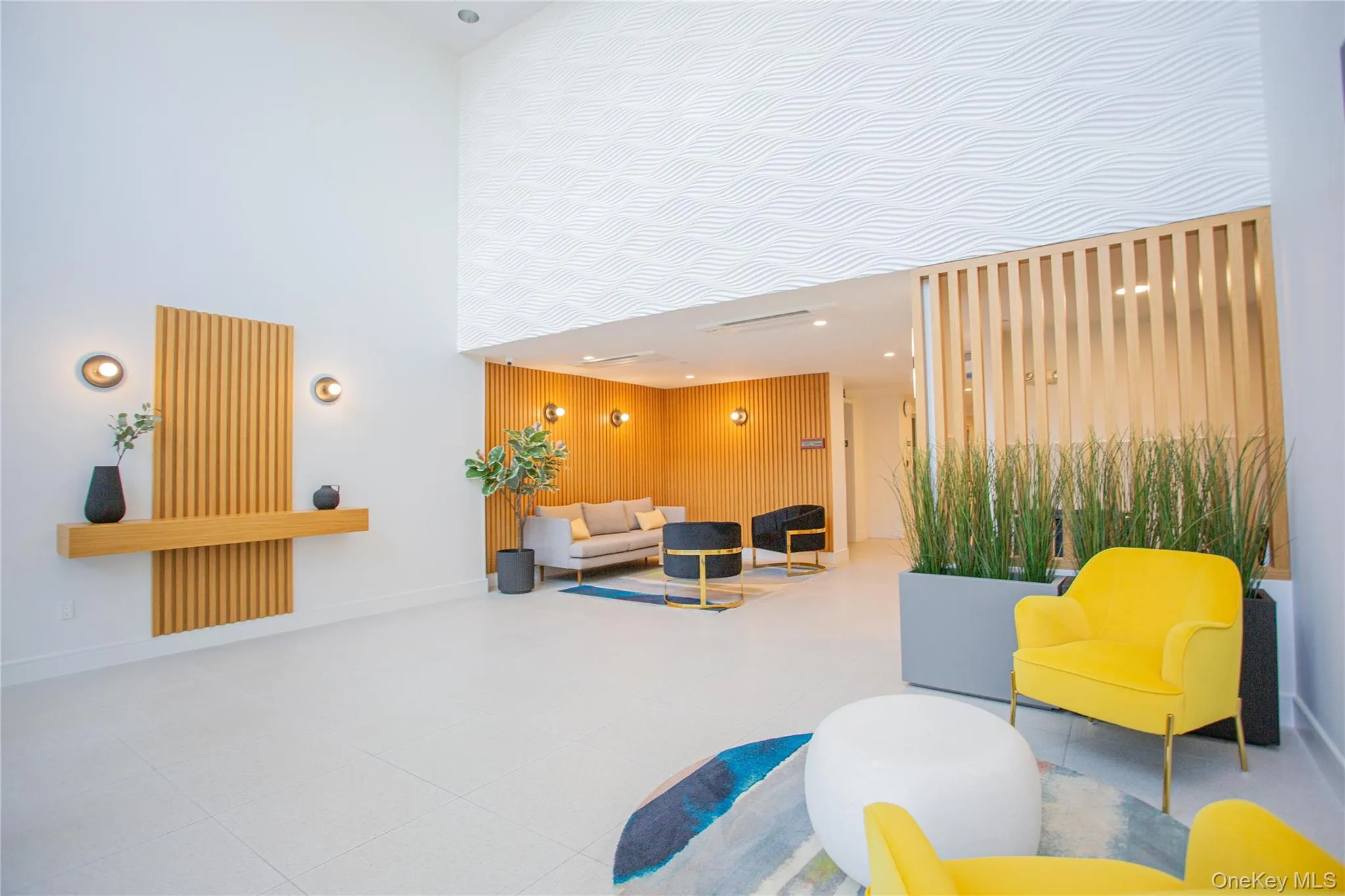 Lobby with a high ceiling, recessed lighting, and wooden walls Lobby with a high ceiling, recessed lighting, and wooden walls