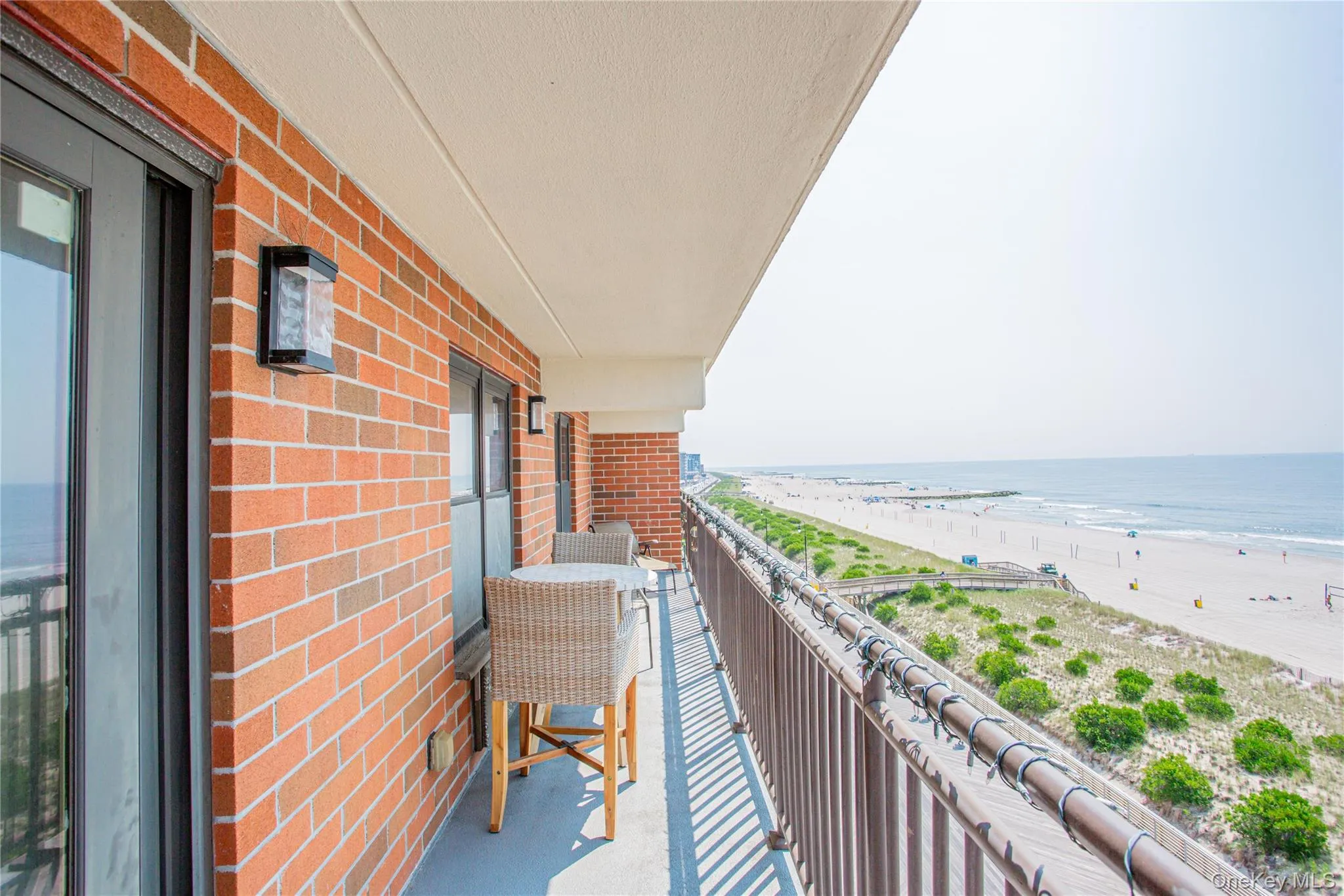 Balcony featuring view of water and beach Balcony featuring view of water and beach