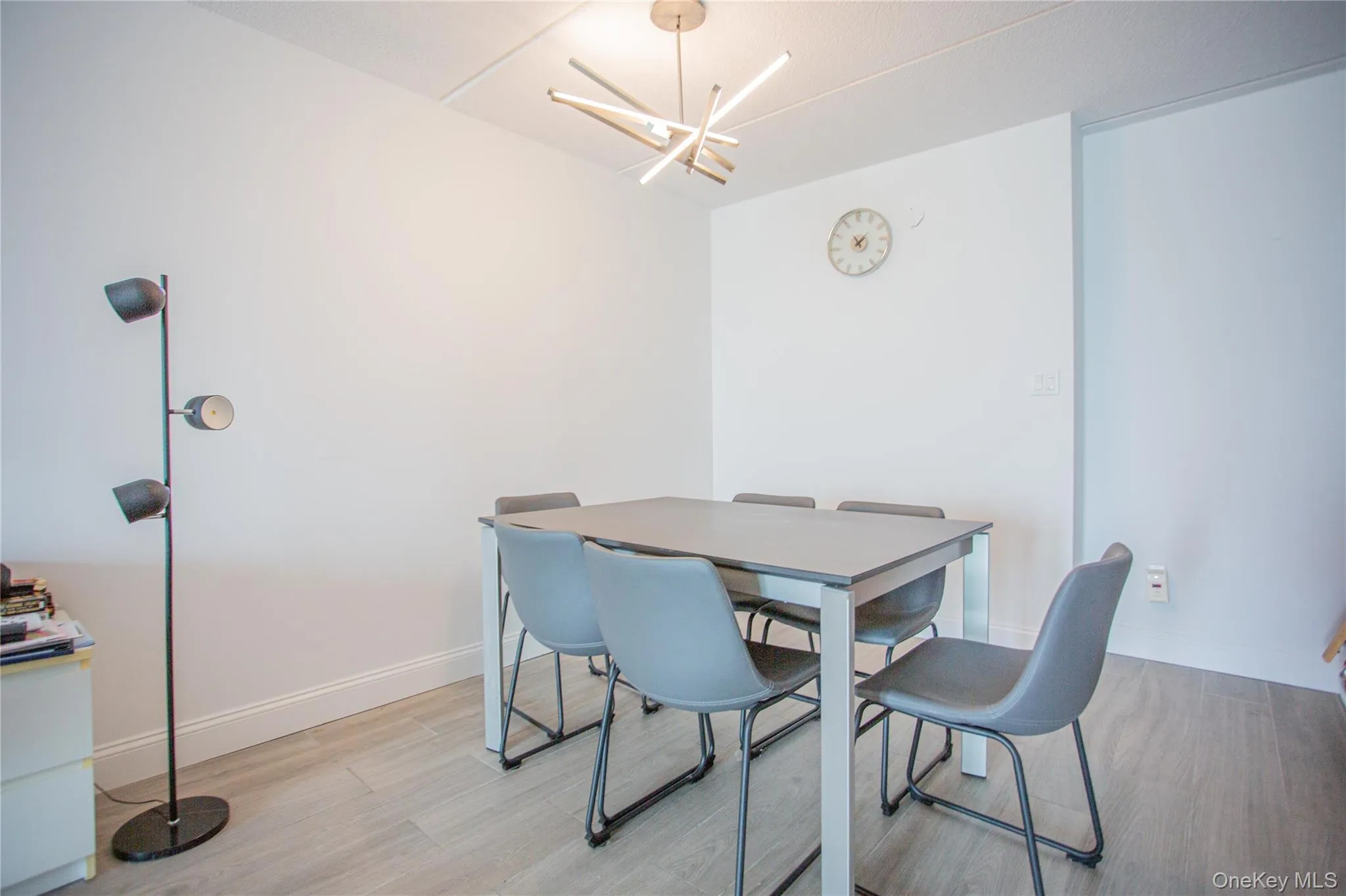 Dining space featuring light wood-style floors and a chandelier Dining space featuring light wood-style floors and a chandelier