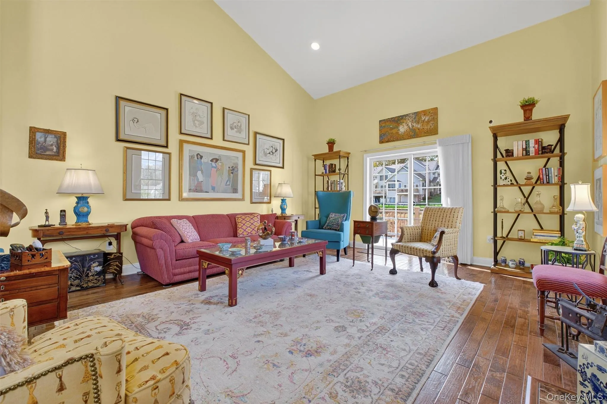 Living room with high vaulted ceiling, dark wood-style floors, and recessed lighting Living room with high vaulted ceiling, dark wood-style floors, and recessed lighting