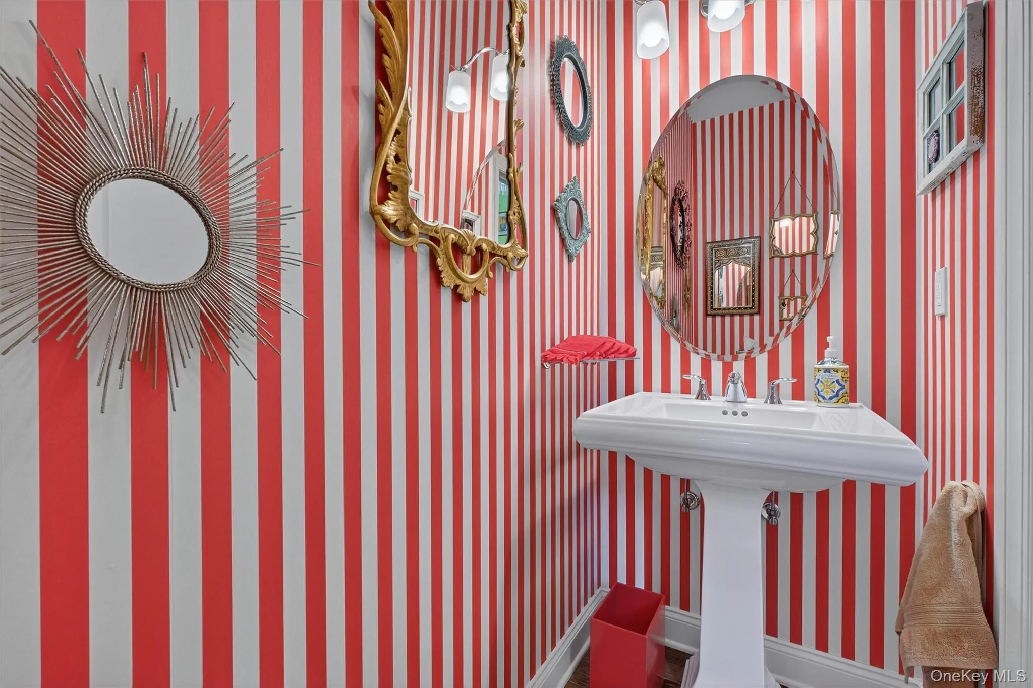 Bathroom with wallpapered walls and baseboards Bathroom with wallpapered walls and baseboards
