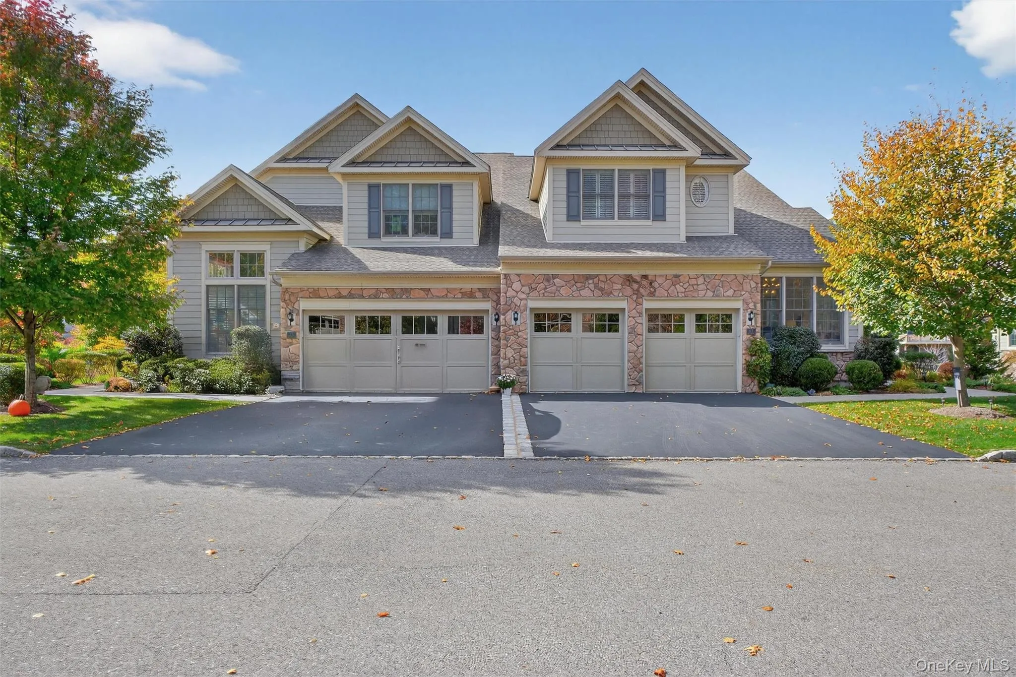 Craftsman house with stone siding, driveway, an attached garage, and a shingled roof Craftsman house with stone siding, driveway, an attached garage, and a shingled roof