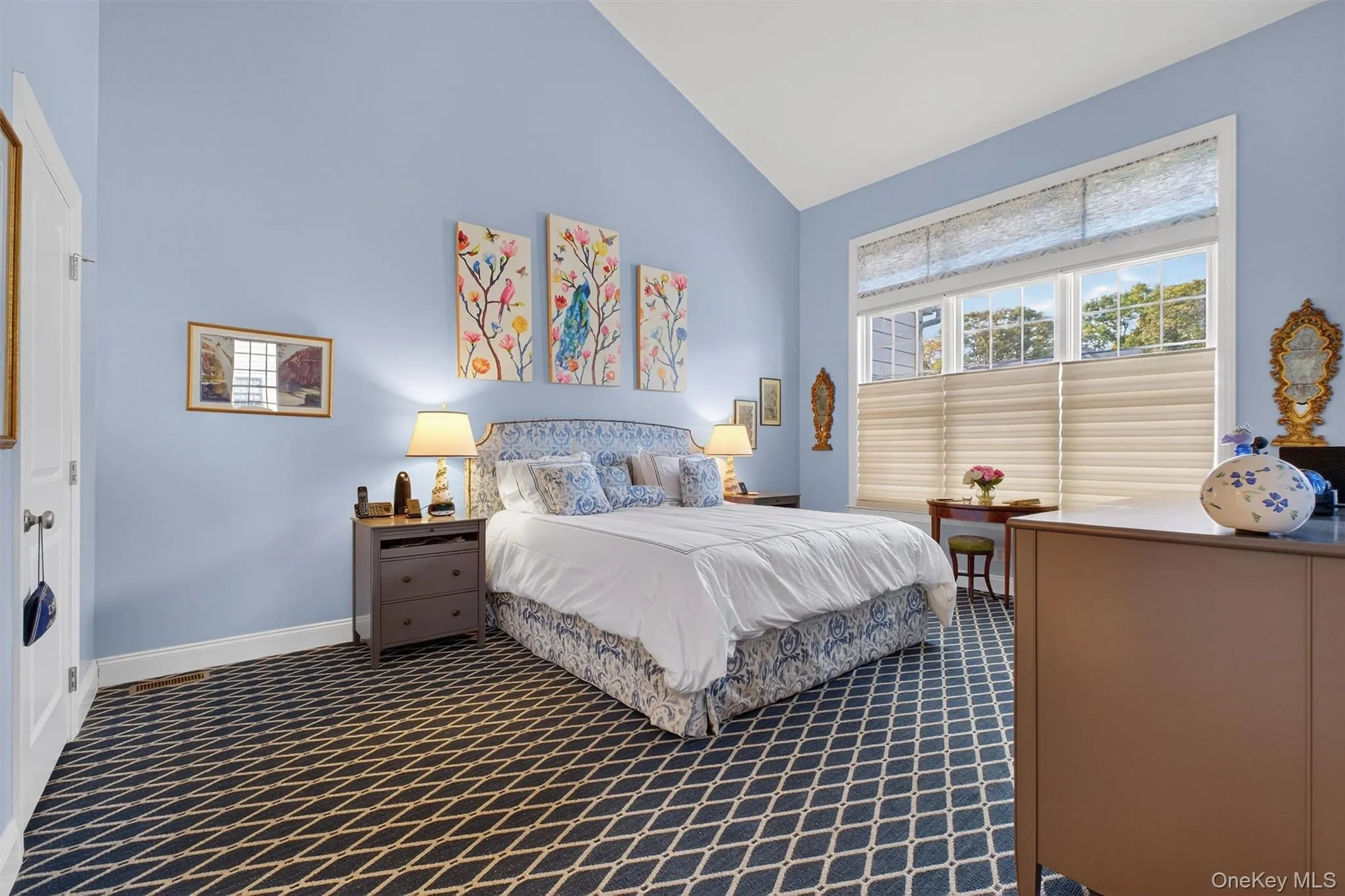 Bedroom featuring high vaulted ceiling and dark carpet Bedroom featuring high vaulted ceiling and dark carpet