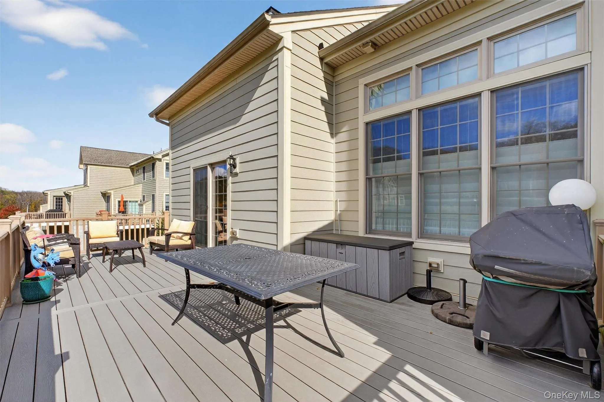Wooden terrace featuring a grill and an outdoor living space Wooden terrace featuring a grill and an outdoor living space